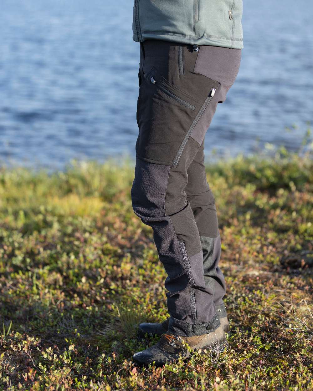 Black Coloured Pinewood Womens Abisko Adventure Trousers on coastal background #colour_black