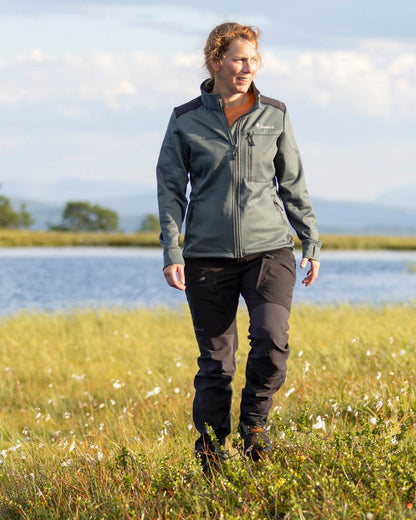 Black Coloured Pinewood Womens Abisko Adventure Trousers on outdoor background #colour_black