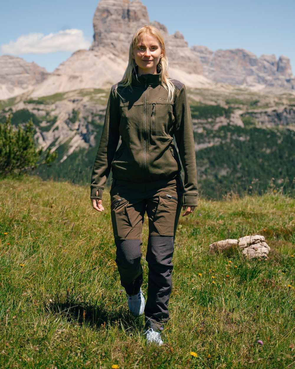 Moss Green Coloured Pinewood Womens Abisko Adventure Trousers on mountain background #colour_moss-green