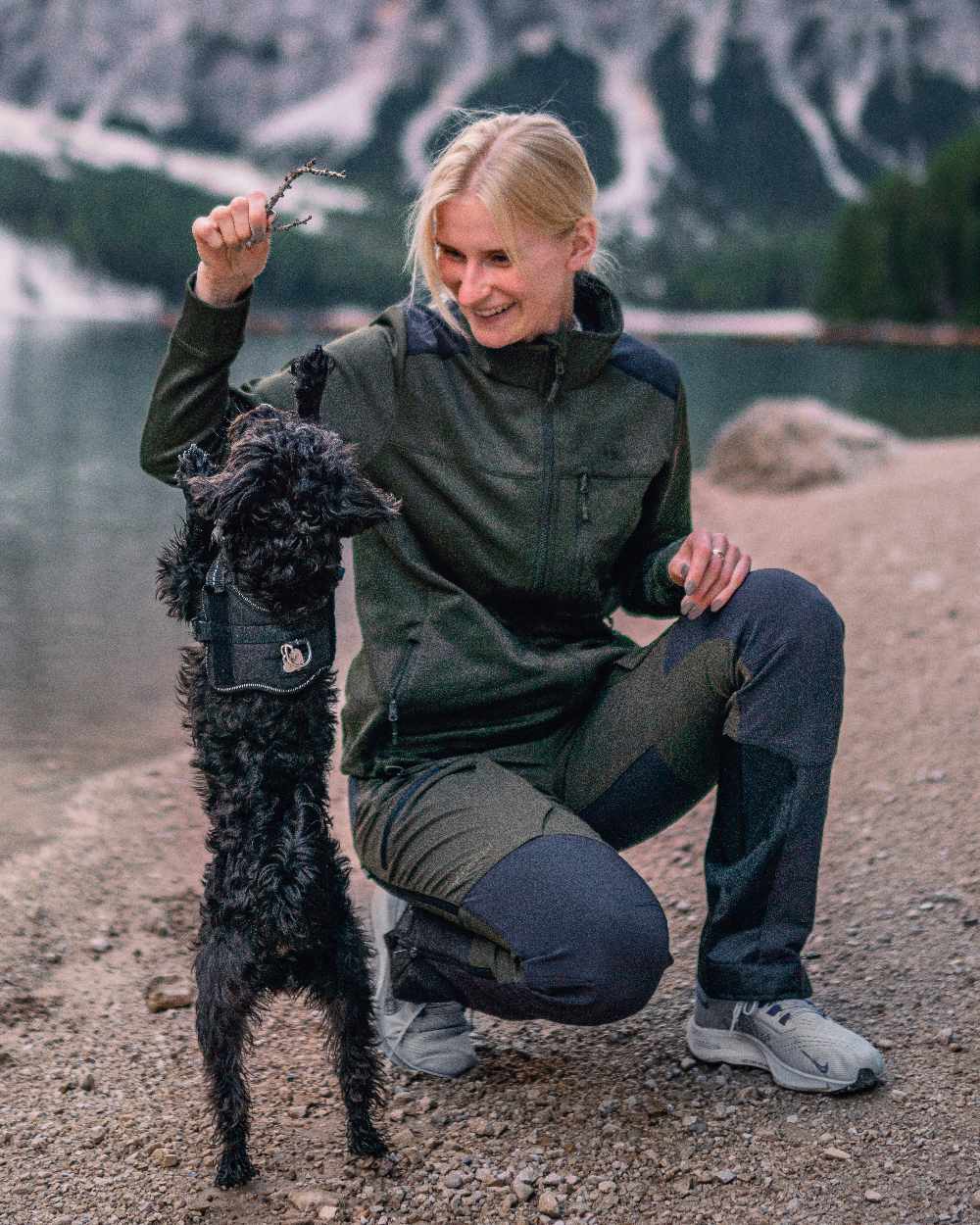 Moss Green Coloured Pinewood Womens Abisko Adventure Trousers on mountain background #colour_moss-green