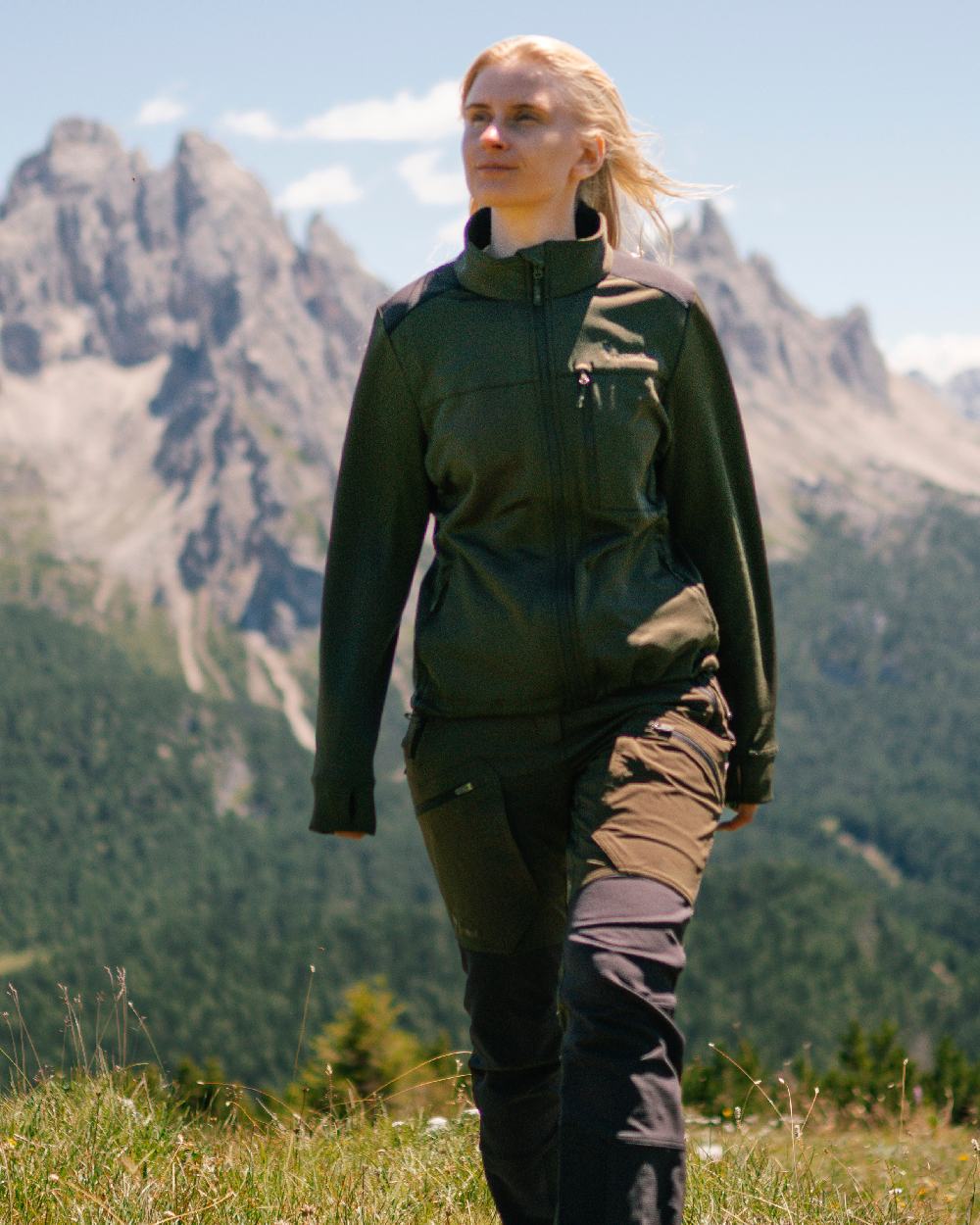 Moss Green Coloured Pinewood Womens Abisko Adventure Trousers on mountain background #colour_moss-green