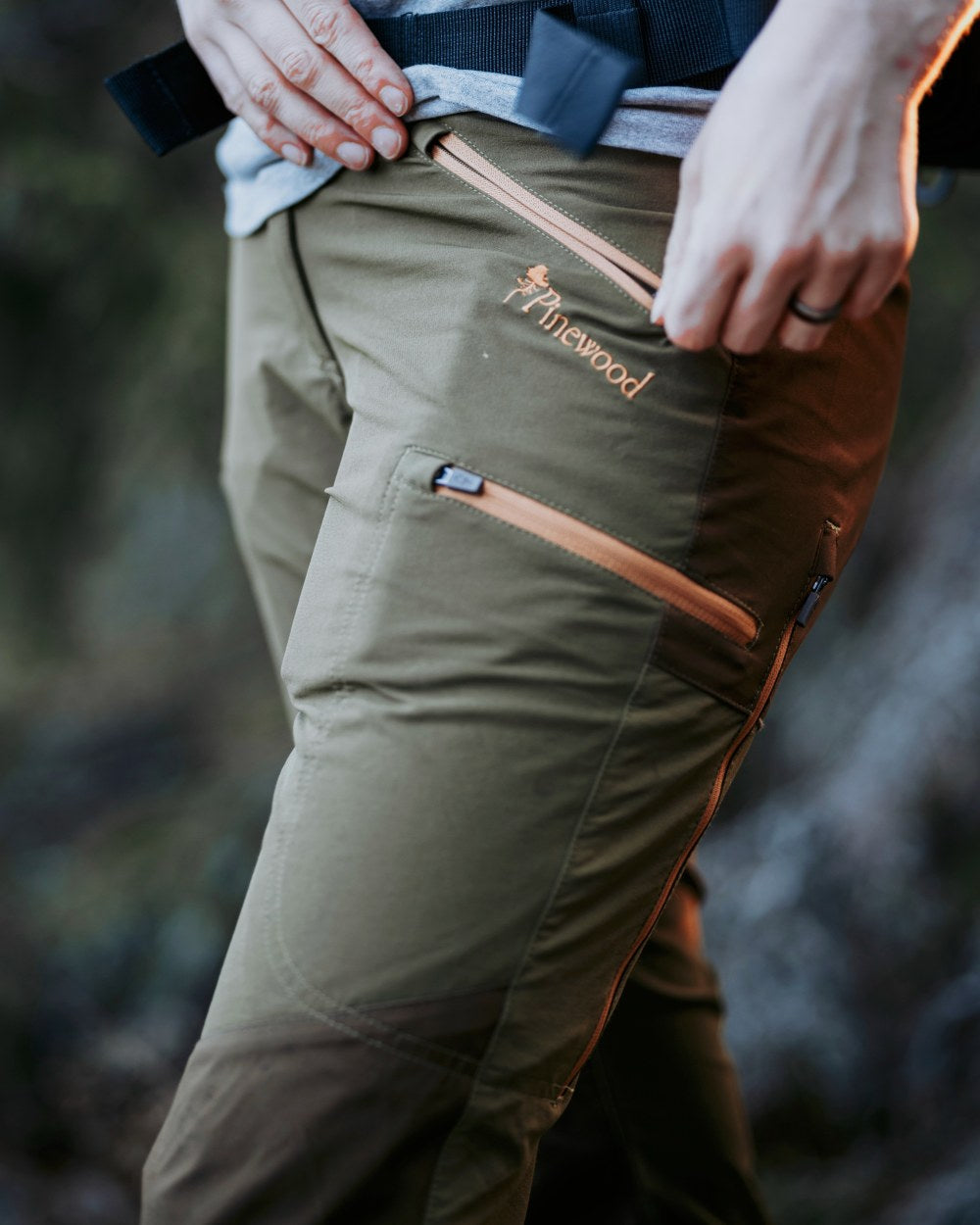Leaf Hunting Olive Coloured Pinewood Womens Abisko Brenton Trousers on outdoor background #colour_leaf-hunting-olive