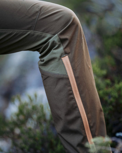 Leaf Hunting Olive Coloured Pinewood Womens Abisko Brenton Trousers on outdoor background #colour_leaf-hunting-olive