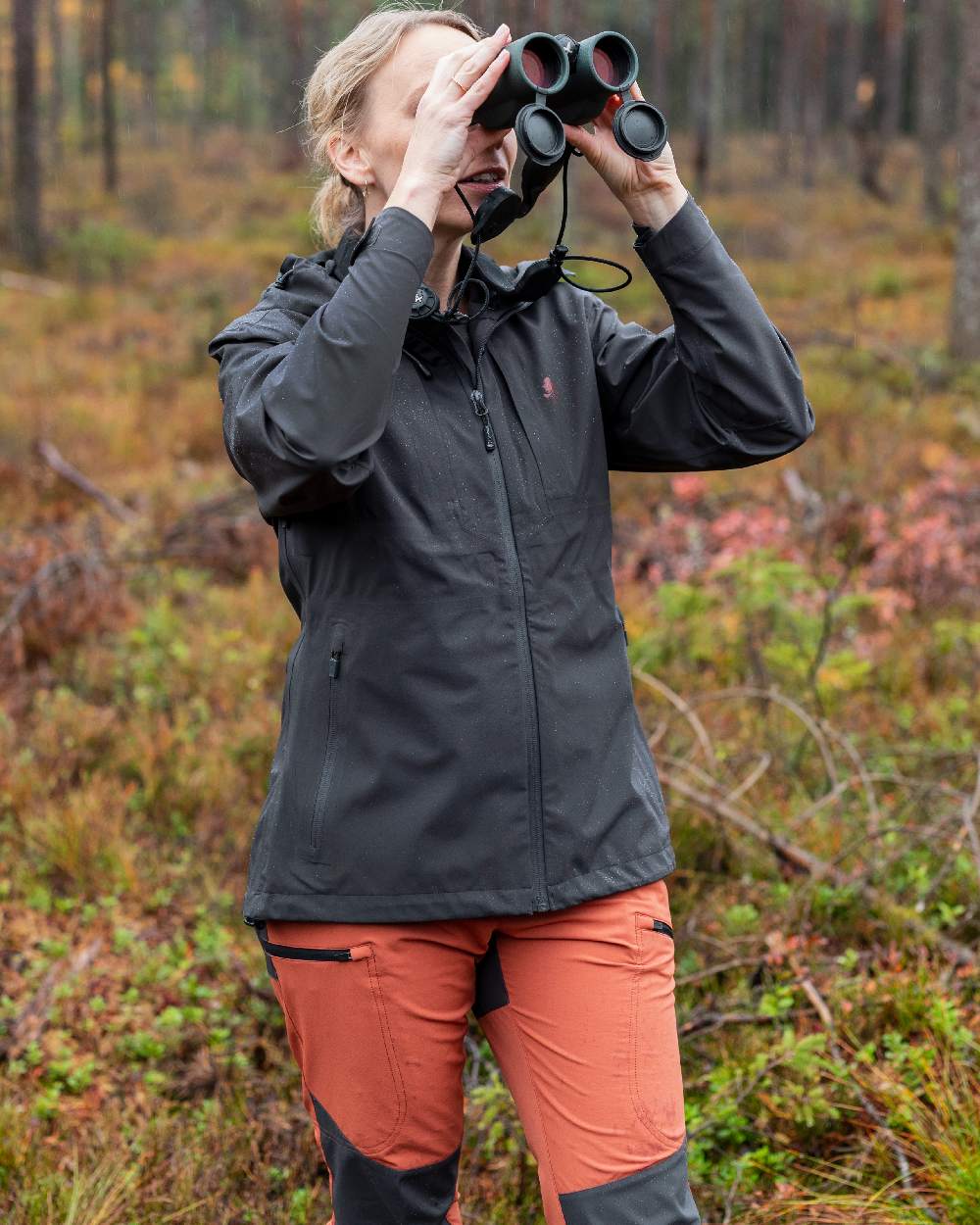 Terracotta Dark Anthracite Coloured Pinewood Womens Abisko Brenton Trousers on forest background #colour_terracotta-dark-anthracite