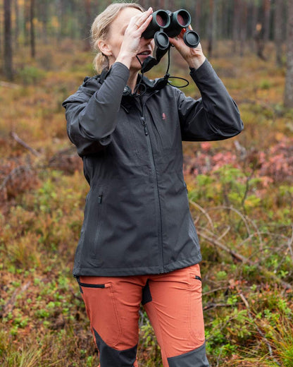Terracotta Dark Anthracite Coloured Pinewood Womens Abisko Brenton Trousers on forest background #colour_terracotta-dark-anthracite