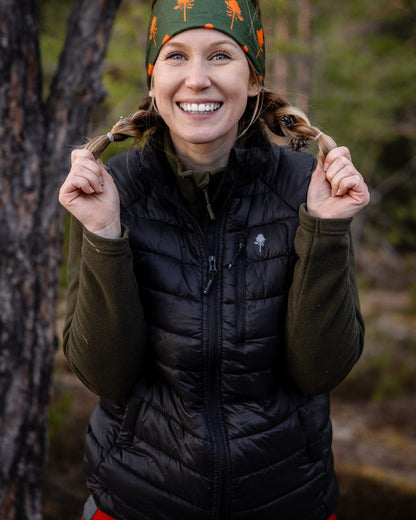 Black Coloured Pinewood Womens Abisko Insulation Vest on forest background #colour_black