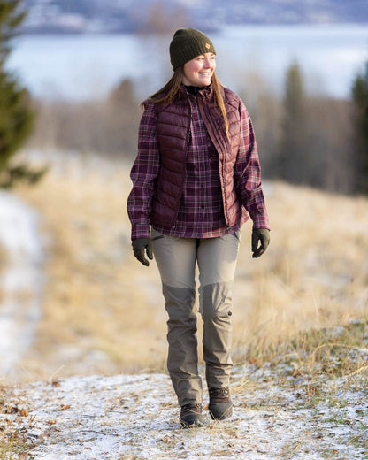 Earth Plum Coloured Pinewood Womens Abisko Insulation Vest on outdoor background #colour_earth-plum