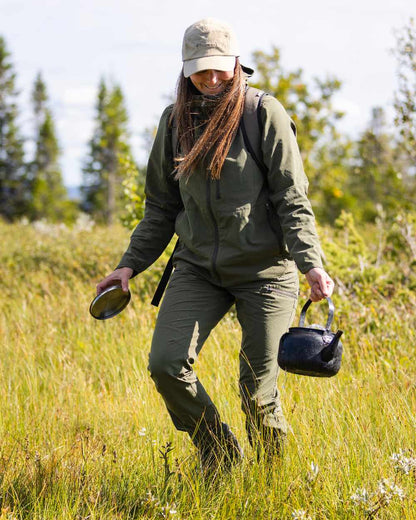 Mossgreen Coloured Pinewood Womens Abisko Light Stretch Jacket on outdoor background #colour_mossgreen