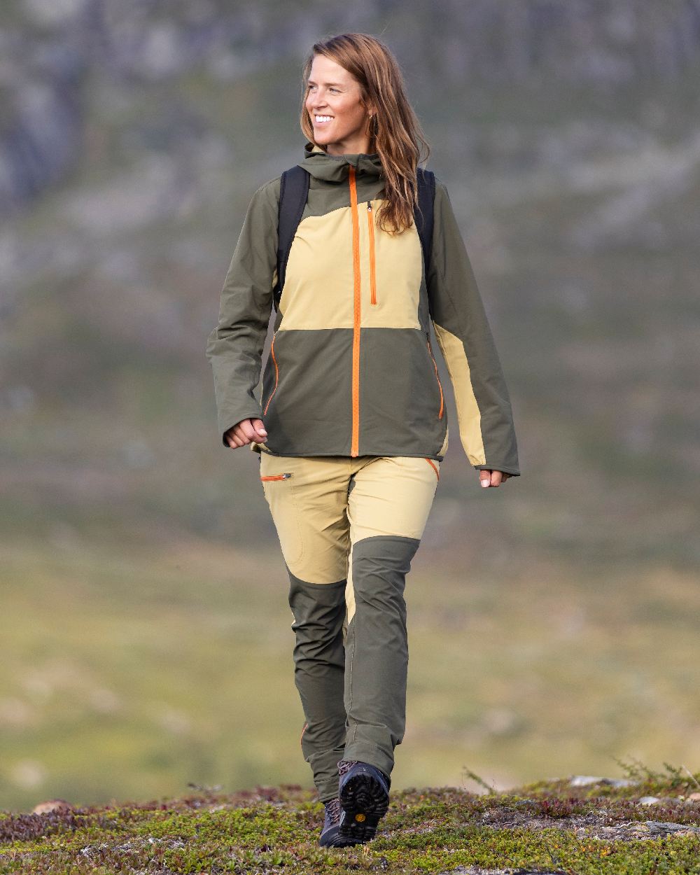 Golden Hay Mossgreen Coloured Pinewood Womens Abisko Light Stretch Trousers on outdoor background #colour_golden-hay-mossgreen