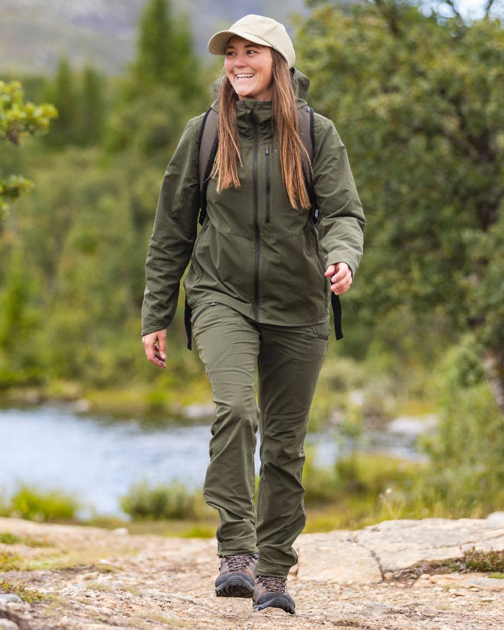 Mossgreen Coloured Pinewood Womens Abisko Light Stretch Trousers on outdoor background #colour_mossgreen