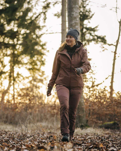 Marron Rose coloured Pinewood Womens Abisko Telluz Three Layer Jacket on forest background #colour_marron-rose