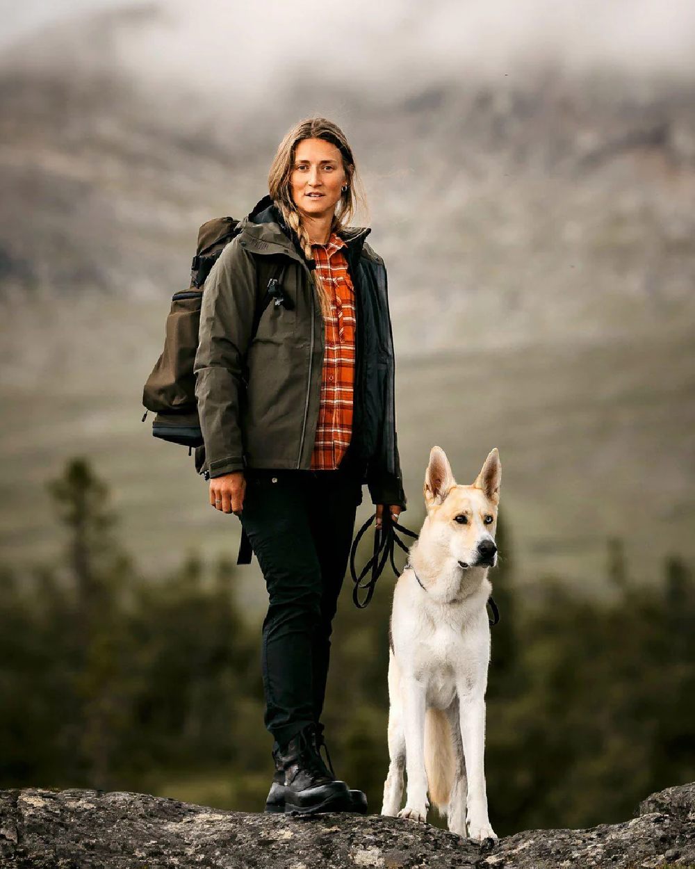 Moss Green coloured Pinewood Womens Abisko Telluz Three Layer Jacket on mountain background #colour_moss-green