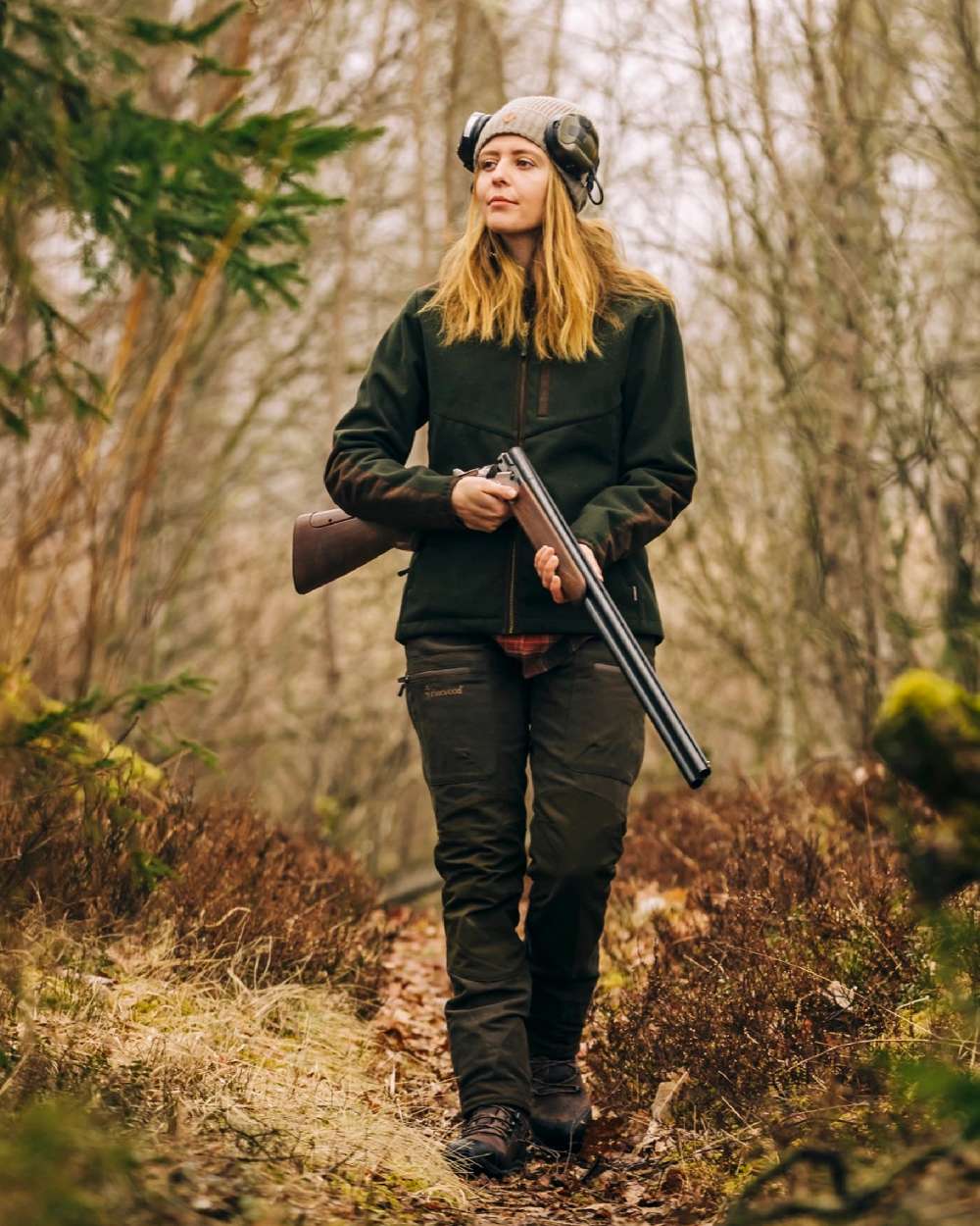 Suede Brown Dark Olive Coloured Pinewood Womens Furudal Caribou Hunt Trousers on forest background #colour_suede-brown-dark-olive
