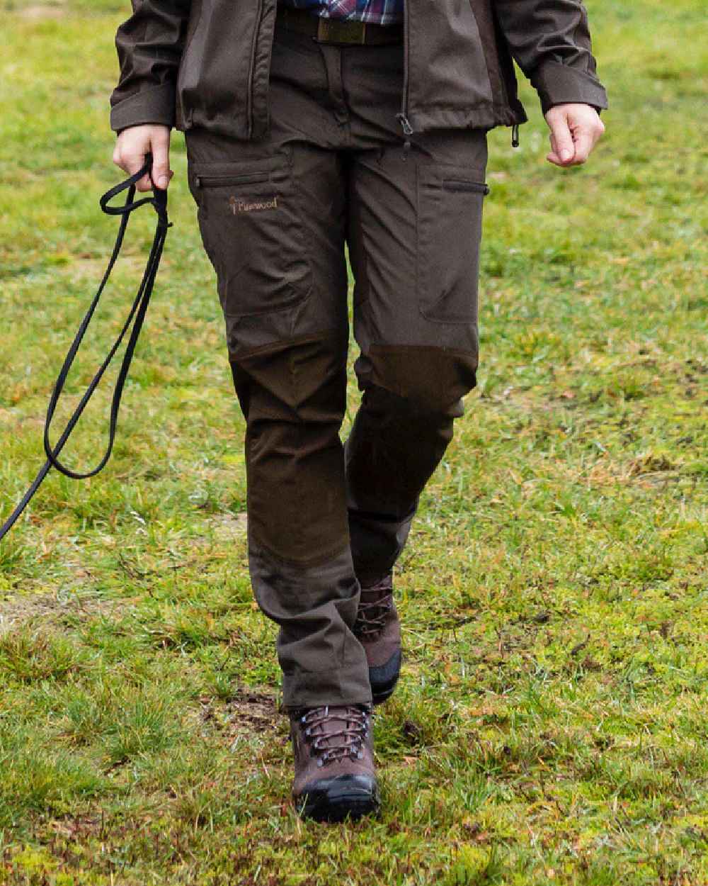 Dark Olive coloured Pinewood Womens Caribou TC Trousers on grass background #colour_dark-olive