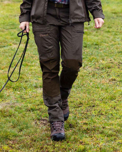 Dark Olive coloured Pinewood Womens Caribou TC Trousers on grass background #colour_dark-olive
