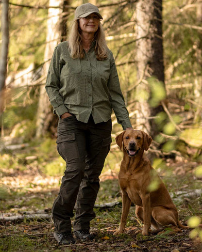 Moss Green Coloured Pinewood Womens Dog Sports Trainer Trousers on outdoor background #colour_moss-green