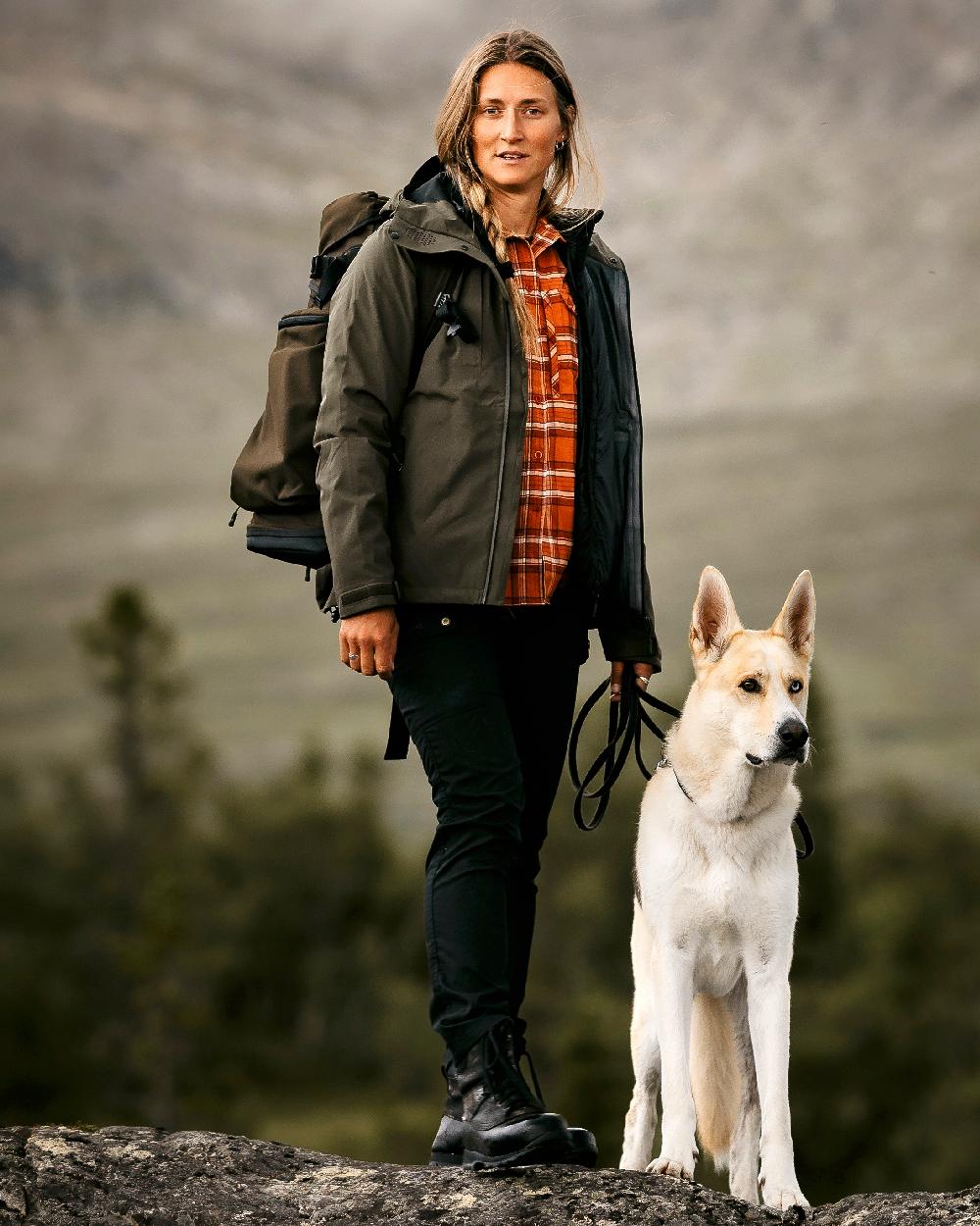 Black Coloured Pinewood Womens Finnveden Classic Trousers on outdoor background #colour_black