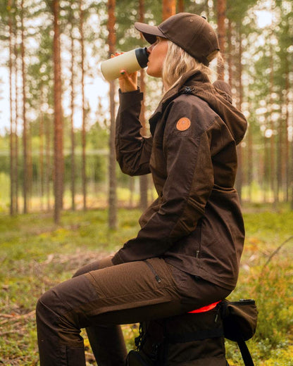 Dark Brown Coloured Pinewood Womens Finnveden Hybrid Jacket on outdoor background #colour_dark-brown
