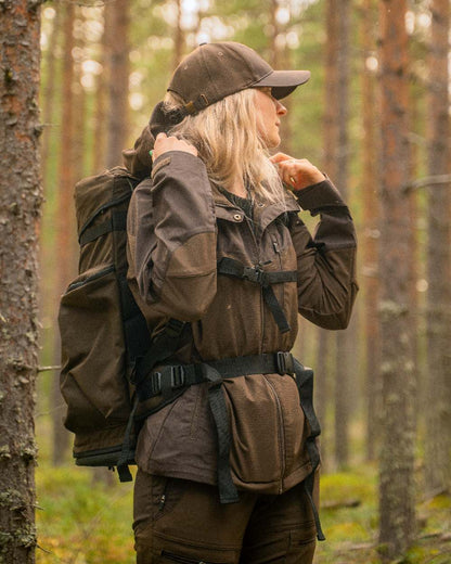 Dark Brown Coloured Pinewood Womens Finnveden Hybrid Jacket on outdoor background #colour_dark-brown