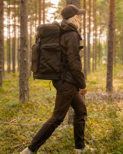 Dark Brown Coloured Pinewood Womens Finnveden Hybrid Trousers on outdoor background #colour_dark-brown