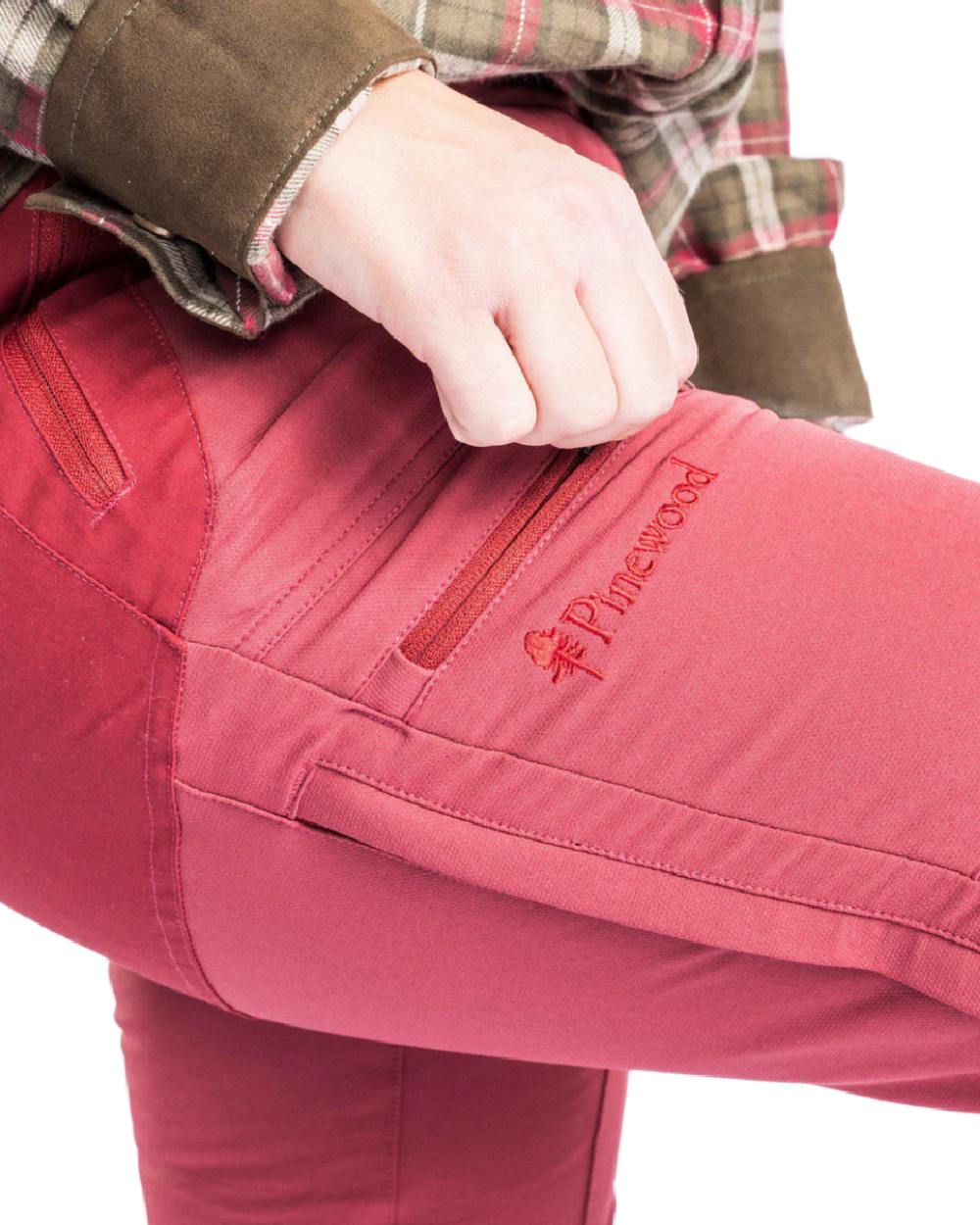 Dark Red Dark Tomato coloured Pinewood Womens Finnveden Hybrid Trousers on white background #colour_dark-red-dark-tomato
