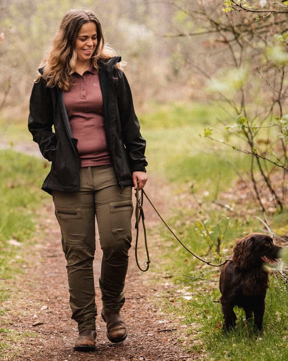 Hunting Olive Coloured Pinewood Womens Finnveden Hybrid Trousers on outdoor background #colour_hunting-olive