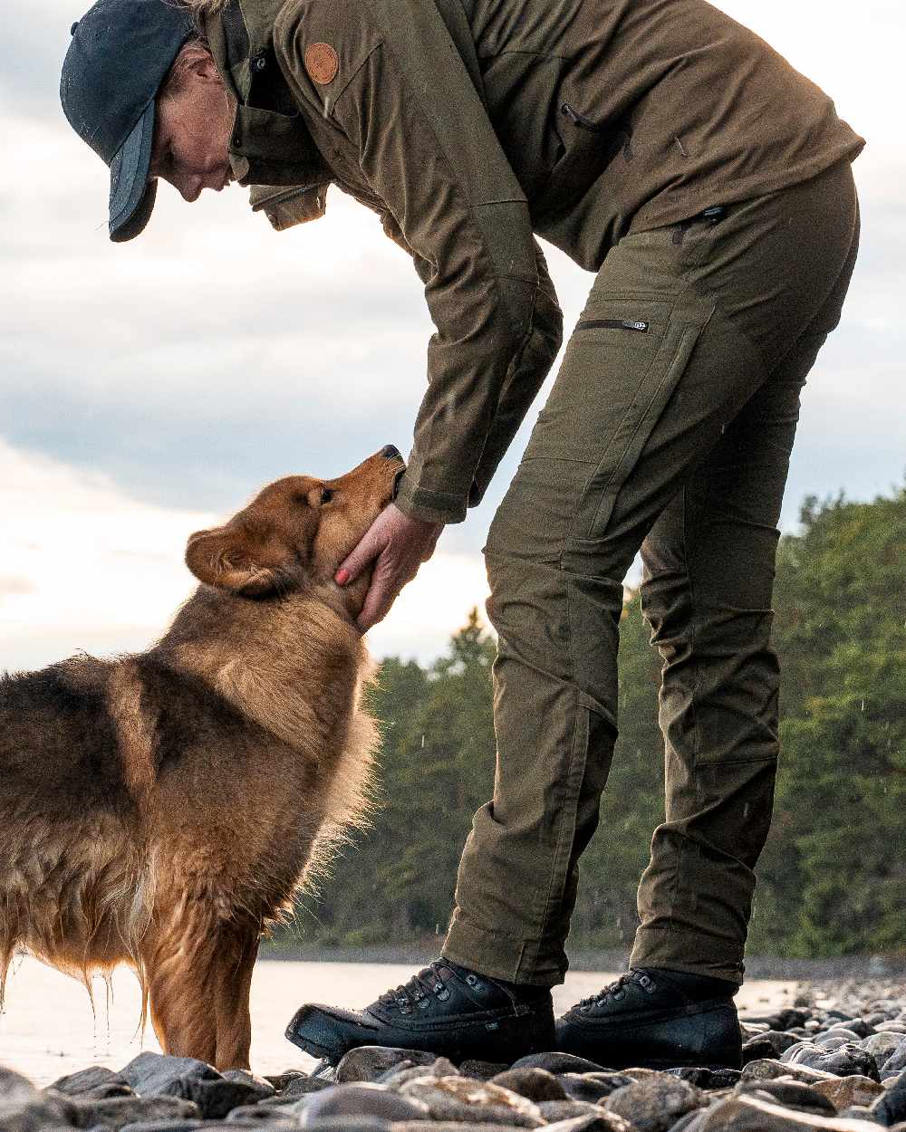 Hunting Olive Coloured Pinewood Womens Finnveden Hybrid Trousers on outdoor background #colour_hunting-olive