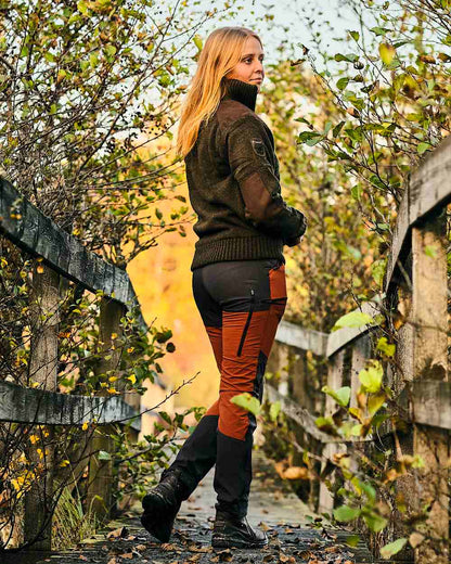 Dark Green Mel Coloured Pinewood Womens Hurricane Knitted Sweater on outdoor background #colour_dark-green-mel