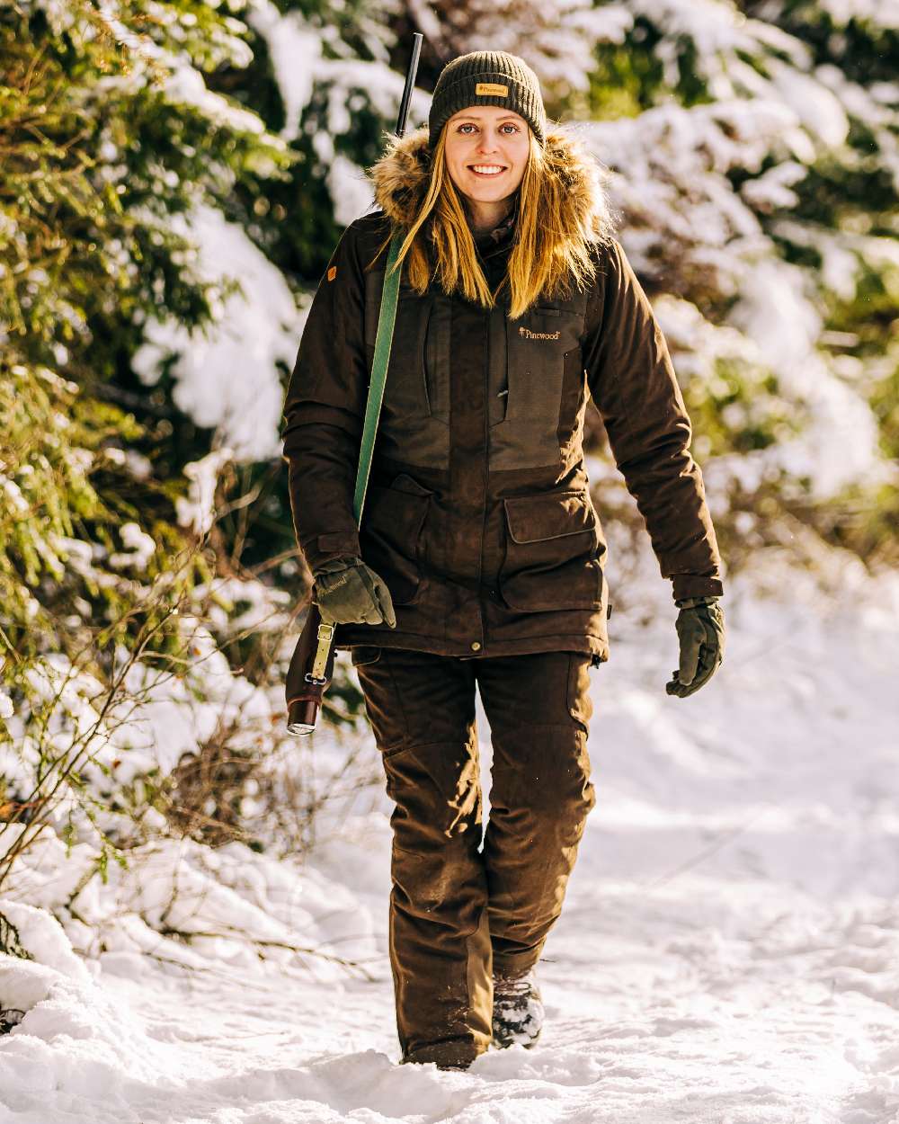 Suede Brown Coloured Pinewood Womens Smaland Abisko 2.0 Hunting Jacket on snow background #colour_suede-brown