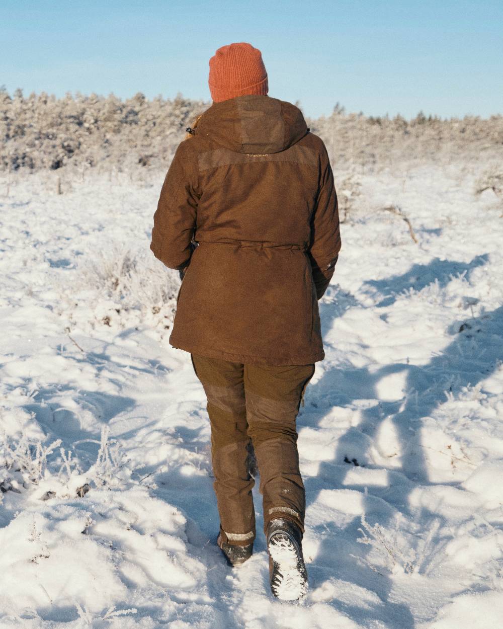 Suede Brown Coloured Pinewood Womens Smaland Abisko 2.0 Hunting Jacket on snow background #colour_suede-brown