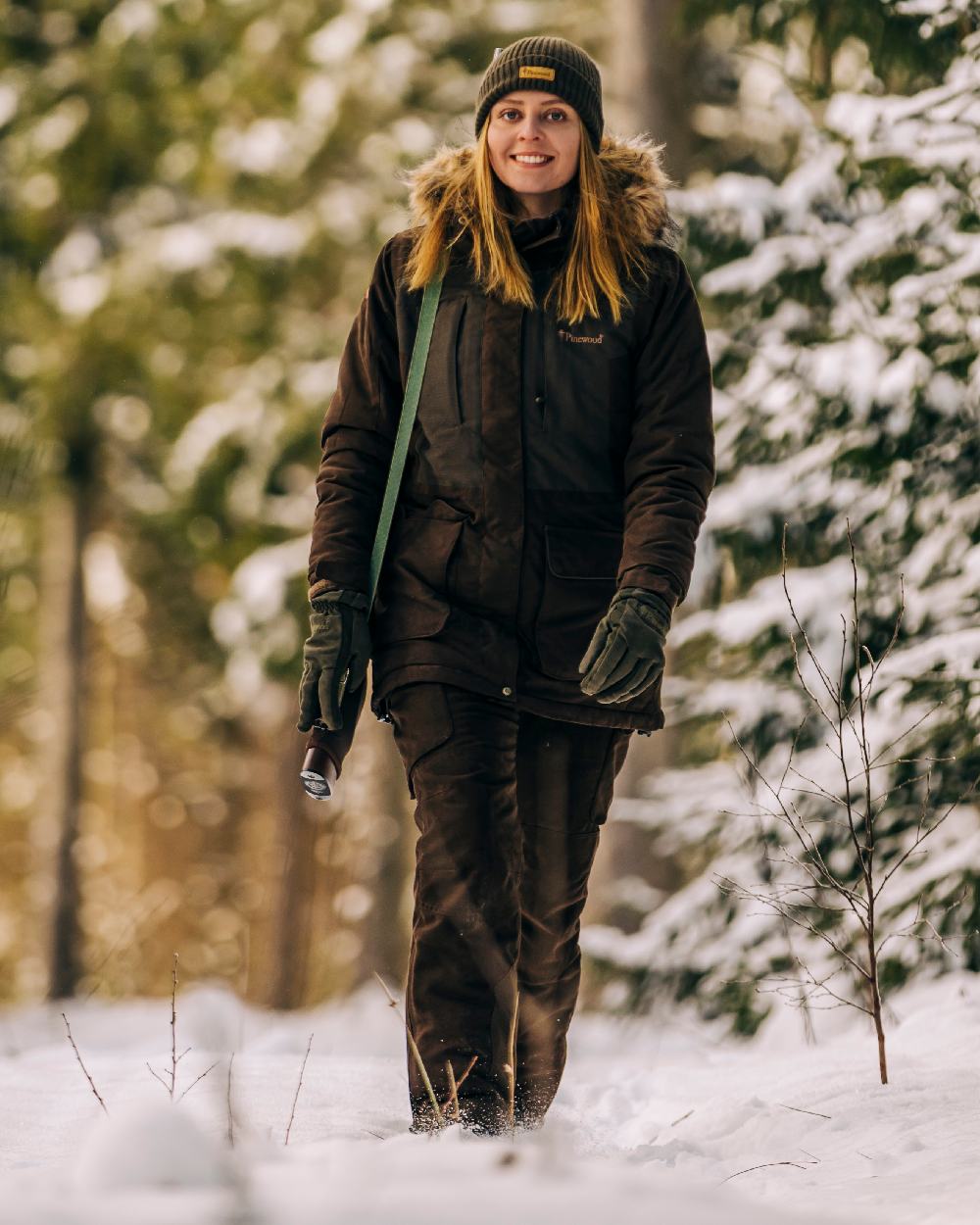 Suede Brown Coloured Pinewood Womens Smaland Abisko 2.0 Hunting Jacket on snow background #colour_suede-brown