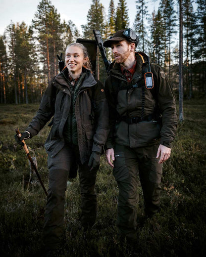 Suede Brown Coloured Pinewood Womens Smaland Hunters Jacket on forest background #colour_suede-brown