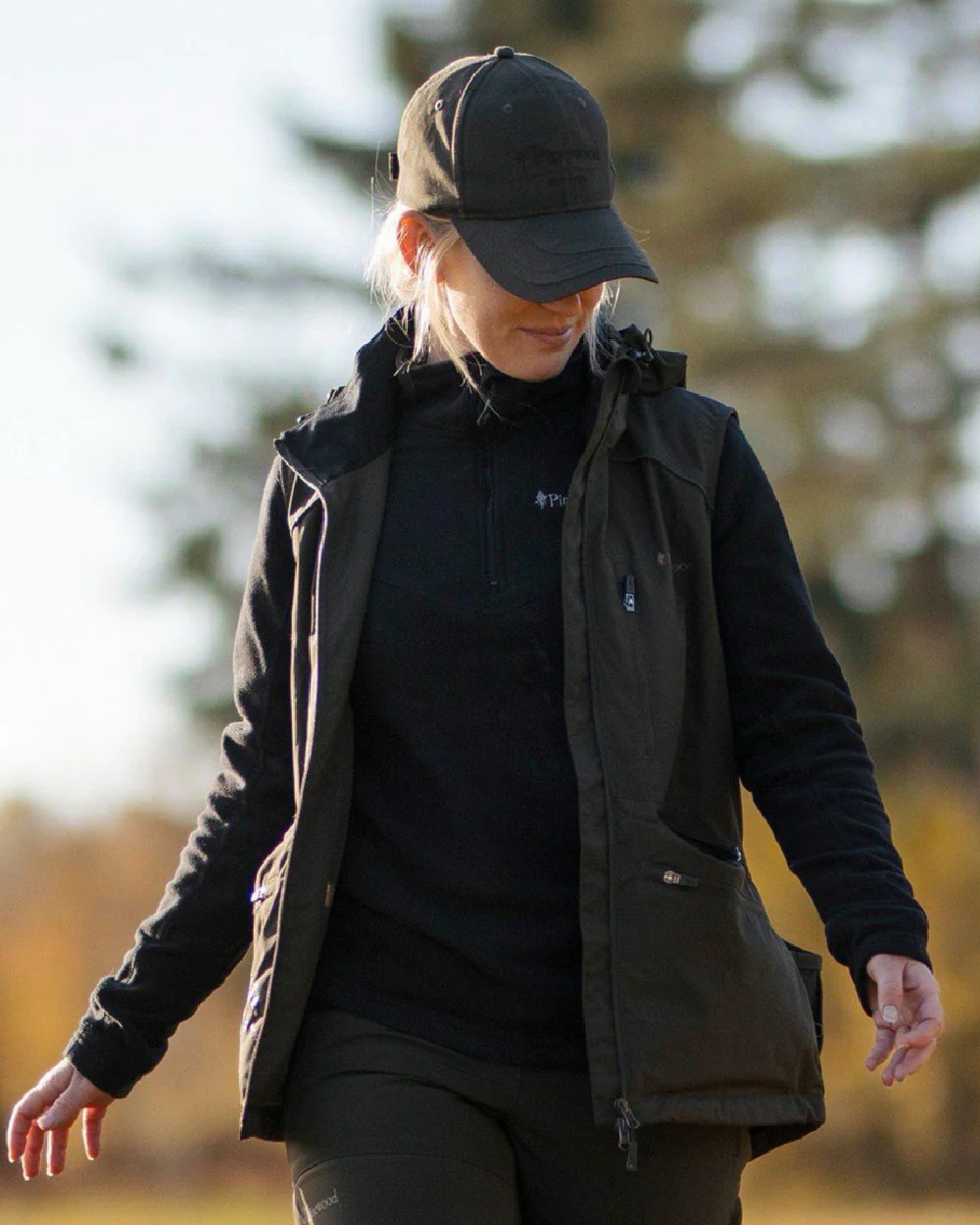 Black coloured Pinewood Womens Tiveden Fleece Sweater on blurry background #colour_black