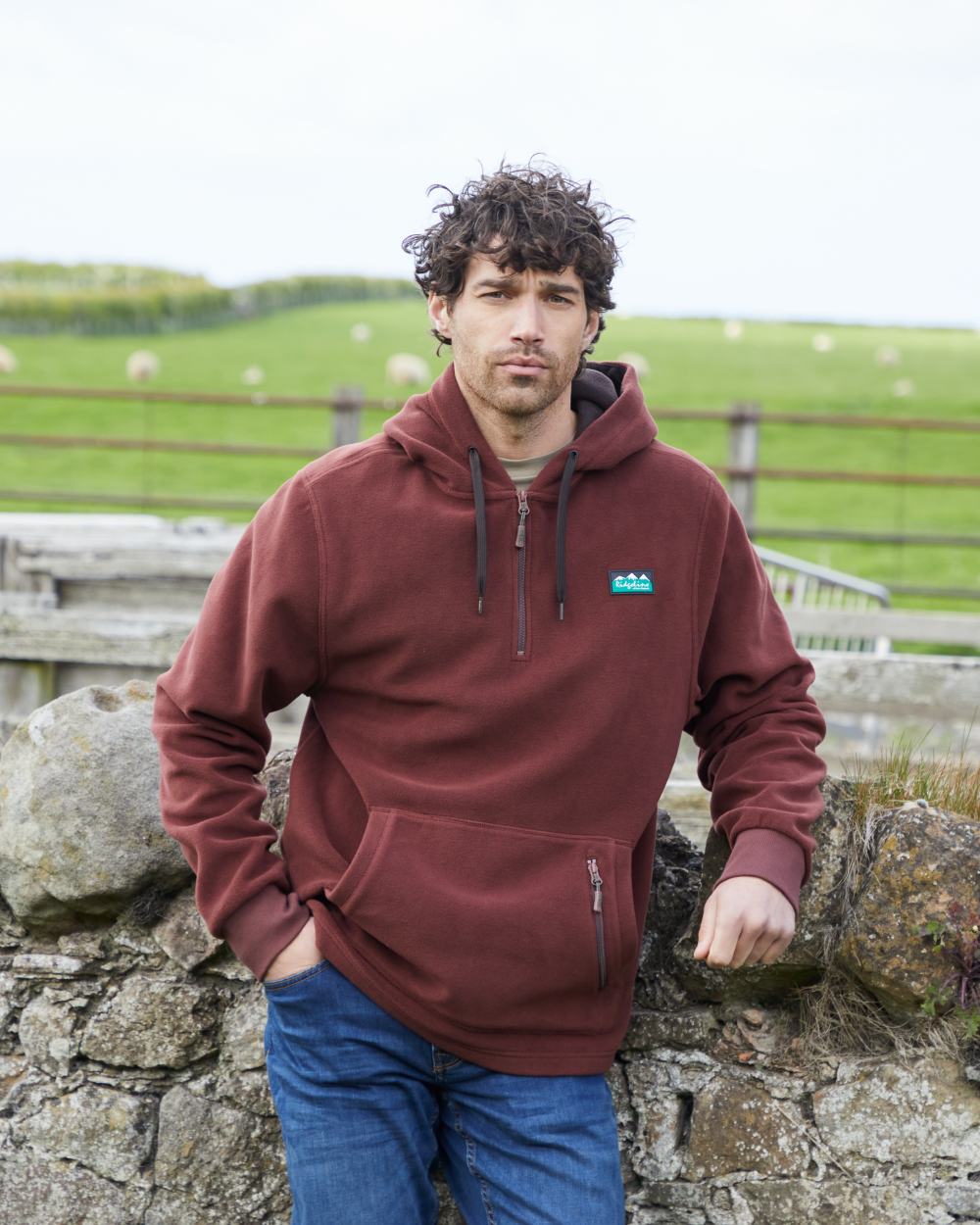 Oxblood coloured Ridgeline Ballistic Hooded Fleece on farm background #colour_oxblood