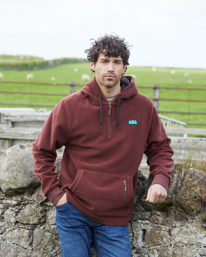 Oxblood coloured Ridgeline Ballistic Hooded Fleece on farm background #colour_oxblood