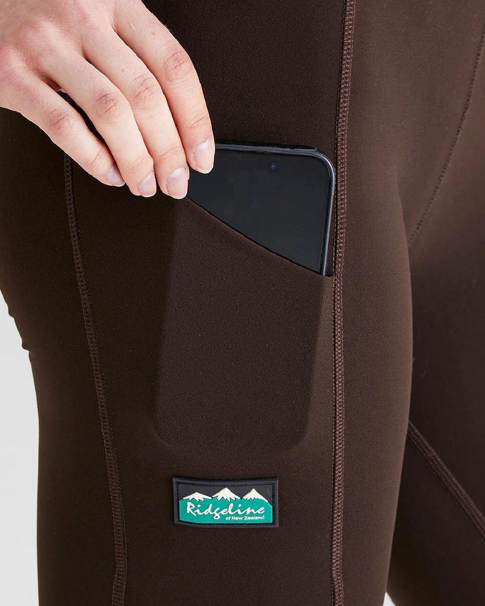 Deep Bark coloured Ridgeline Ladies Infinity Leggings on grey background #colour_deep-green