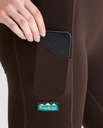 Deep Bark coloured Ridgeline Ladies Infinity Leggings on grey background #colour_deep-green