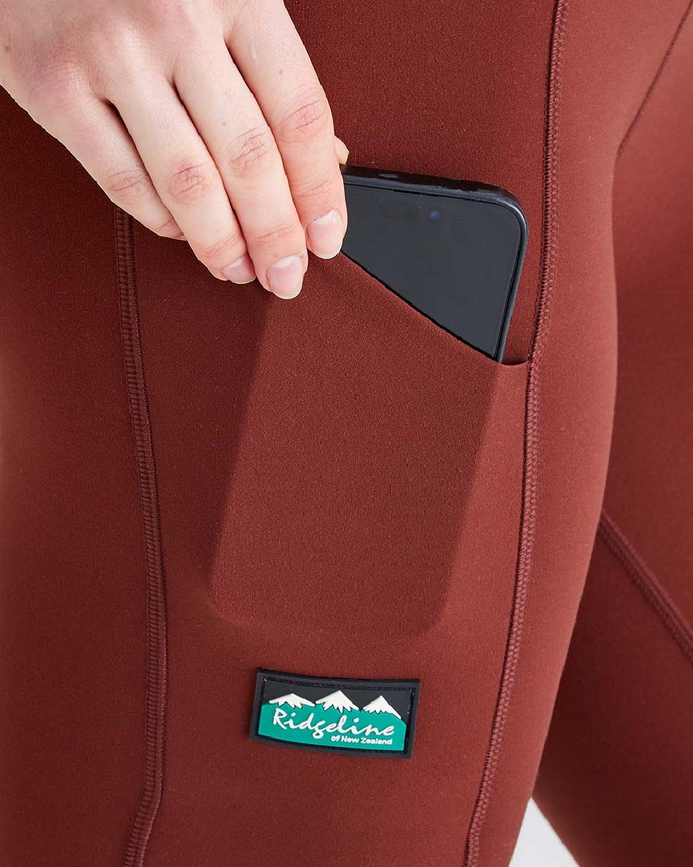 Oxblood coloured Ridgeline Ladies Infinity Leggings on grey background #colour_oxblood