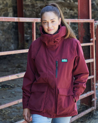 Winter Berry coloured Ridgeline Ladies Rhea Jacket on rock background #colour_winter-berry