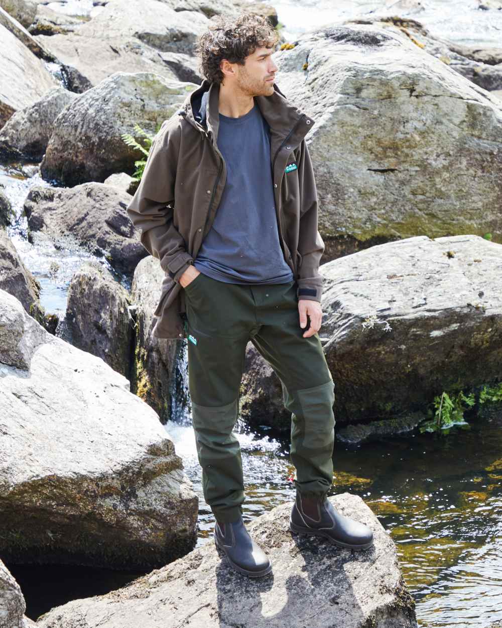 Deep Forest coloured Ridgeline Mens Cambrian Trousers on mountain background #colour_deep-forest