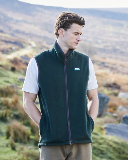 Deep Forest Coloured Ridgeline Mens Kodiak Gilet on hilly background #colour_deep-forest