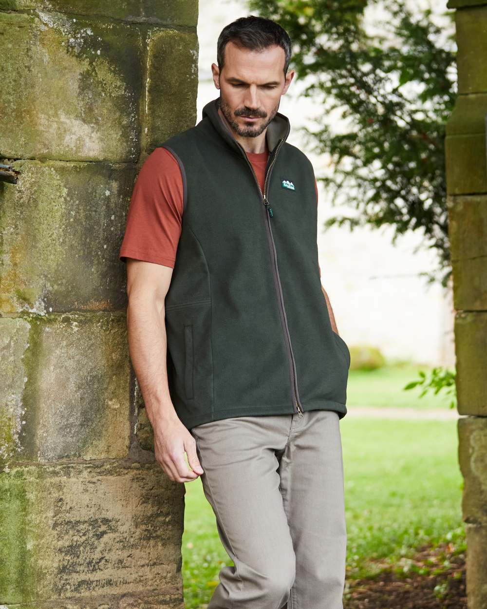 Deep Forest Coloured Ridgeline Mens Kodiak Gilet on hilly background #colour_deep-forest