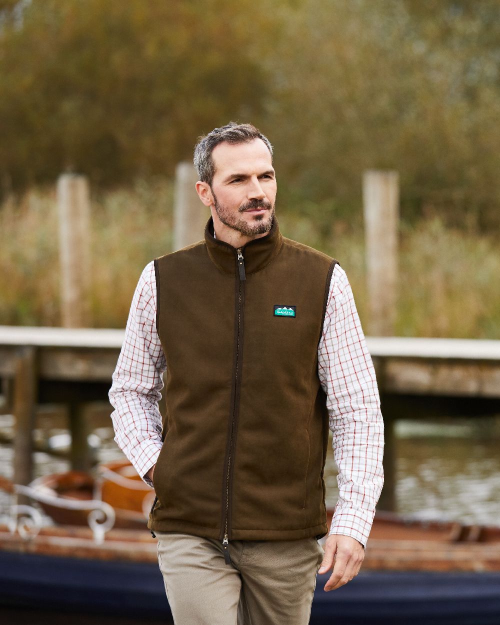 Teak coloured Ridgeline Mens Monarch Gilet on backwater background #colour_teak