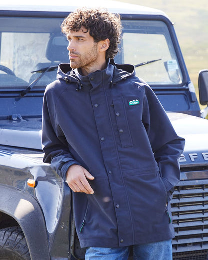 Navy coloured Ridgeline Monsoon Classic Waterproof Jacket on jeep background #colour_navy