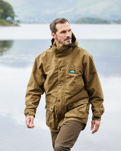 Teak coloured Ridgeline Torrent III Waterproof Jacket on blurry background #colour_teak