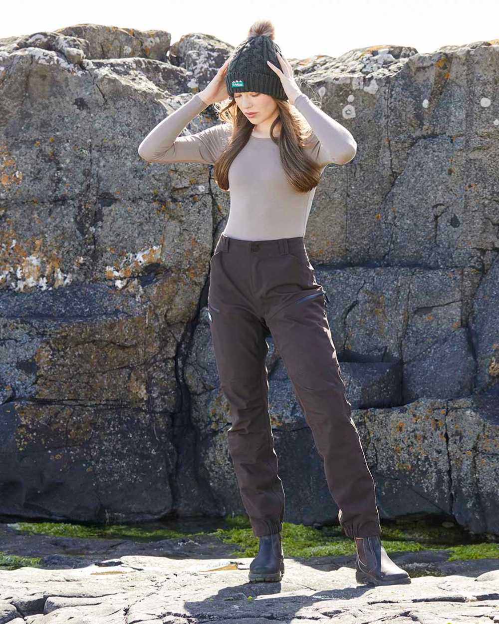 Deep Bark coloured Ridgeline Womens Cambrian Trousers on rocky background #colour_deep-bark