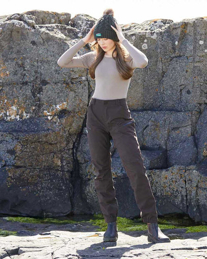 Deep Bark coloured Ridgeline Womens Cambrian Trousers on rocky background #colour_deep-bark
