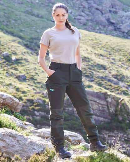 Deep Forest coloured Ridgeline Womens Cambrian Trousers on outdoor background #colour_deep-forest