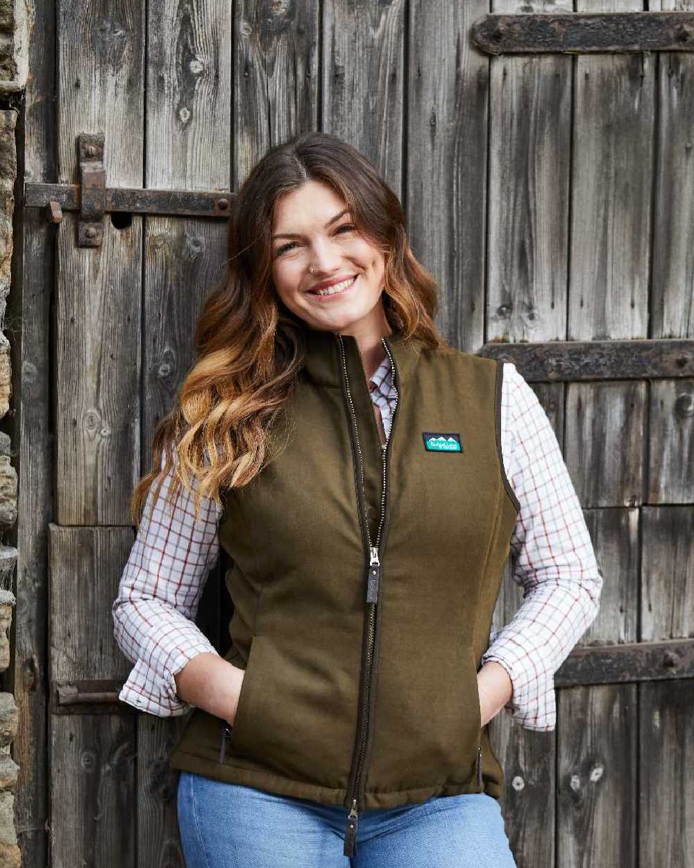 Teak coloured Ridgeline Womens Monarch Gilet on door background #colour_teak