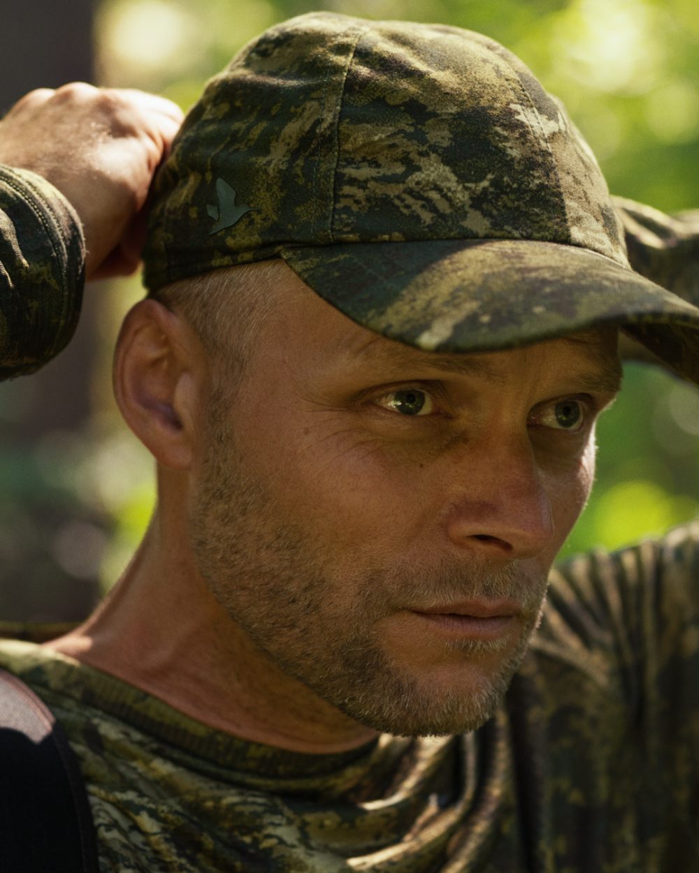 InVis Green Coloured Seeland Avail Camo Cap on forest background #colour_invis-green